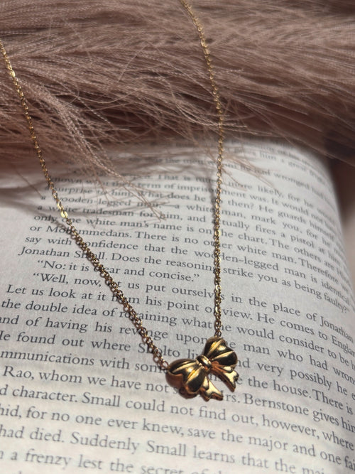 Delicate bow pendant